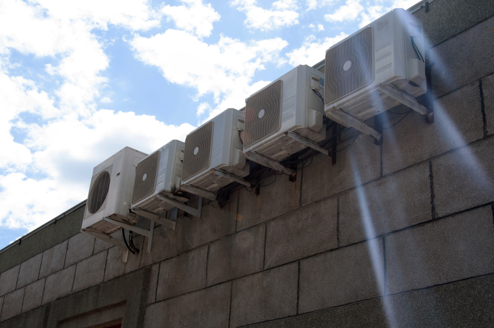 Several outdoor classic evaporative air coolers installed on the wall