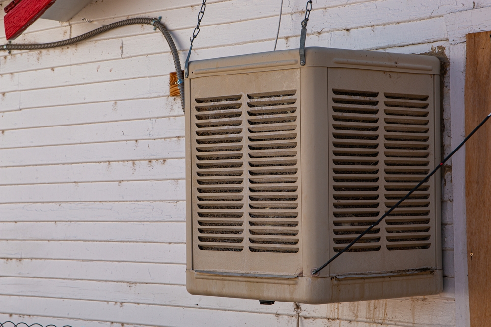 An evaporative swamp cooler on a wall