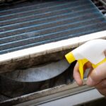 Applying spray to a swamp cooler as maintenance