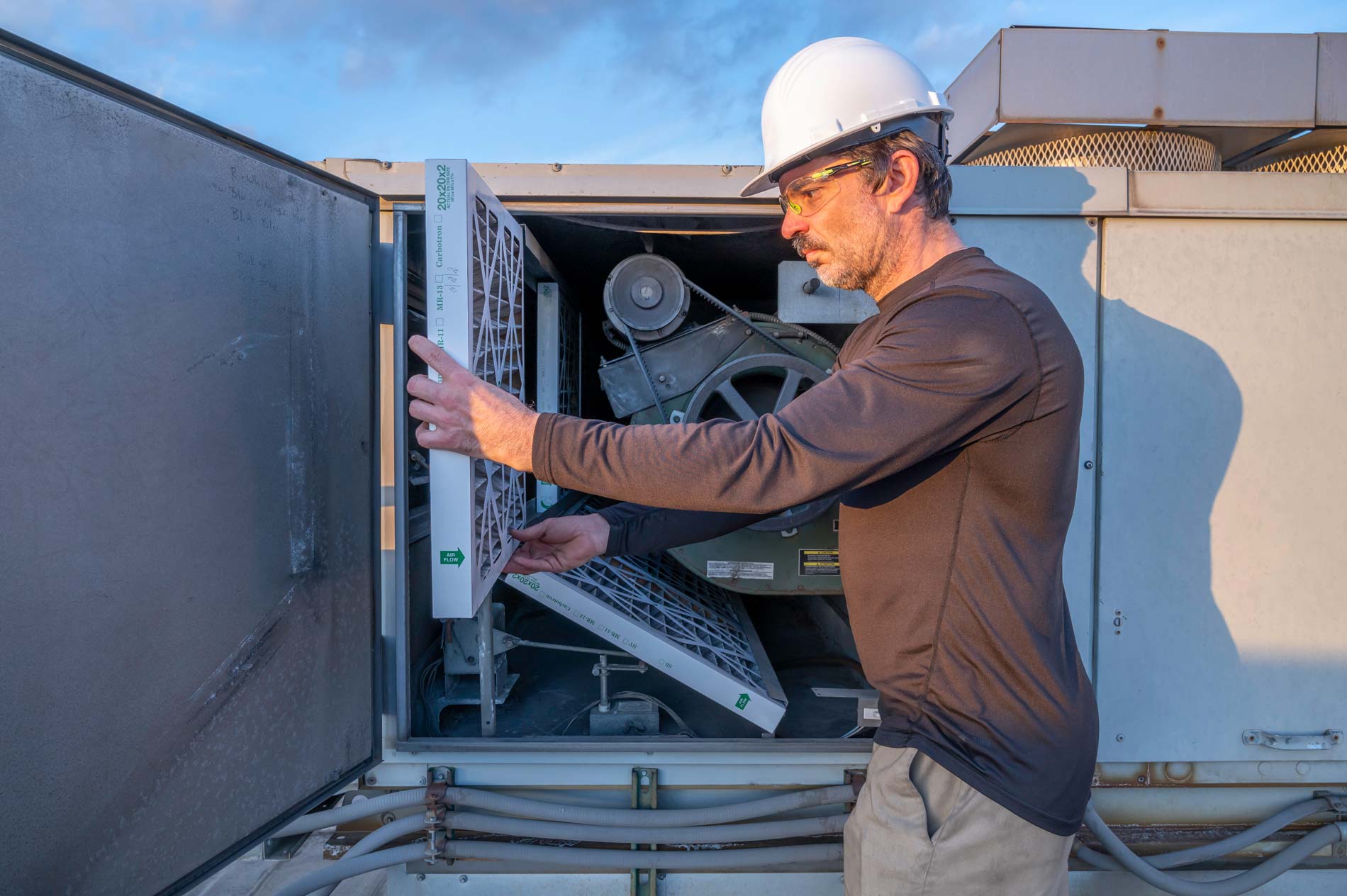 Man preparing a swamp cooler for summer